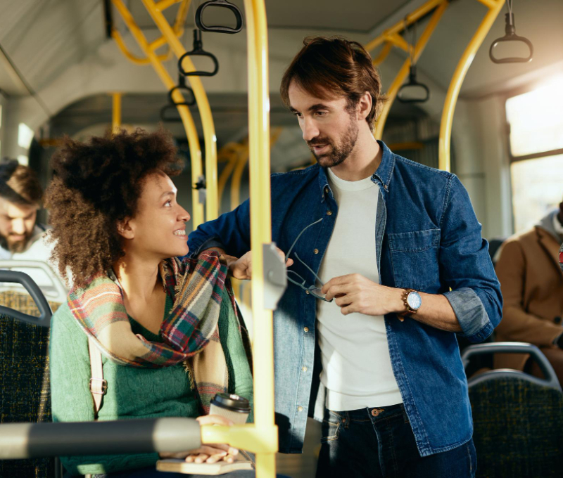happy-couple-talking-each-other-while-commuting-by-bus